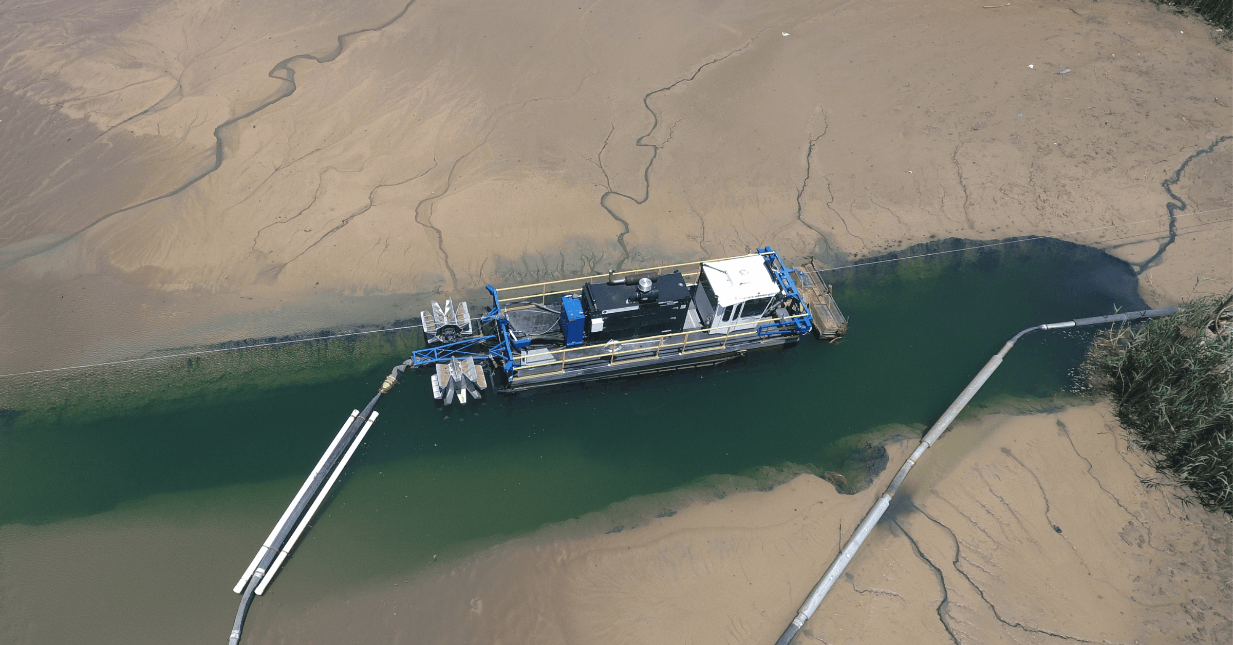 Hydraulic dredging equipment cleaning a wastewater lagoon